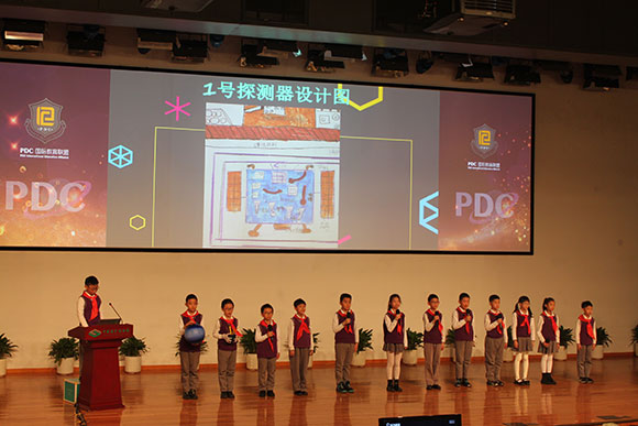 北京呼家樓中心小學(xué)的學(xué)生們展示PDC項(xiàng)目“新行星移民計(jì)劃探索衛(wèi)星設(shè)計(jì)”。